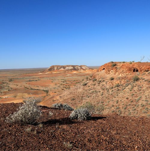 Free Explore the vast desert and rugged terrain of the South Australian outback under a clear blue sky. Stock Photo