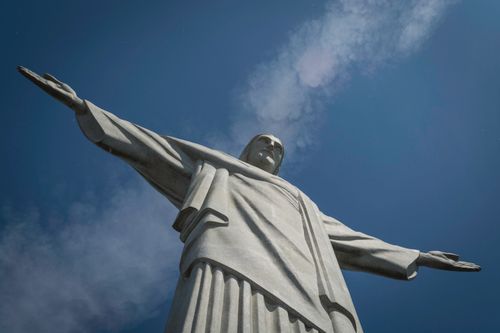 Free Close-up view of Christ the Redeemer statue with arms wide open, set against a clear blue sky. Stock Photo