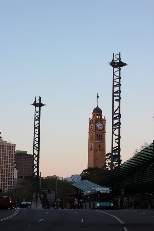 Free View of Sydney Central Station's iconic clock tower with evening sky and city lights. Stock Photo