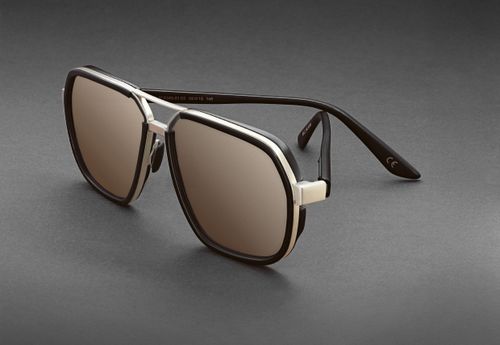 Free Elegant black and silver aviator sunglasses with tinted lenses on a grey backdrop, perfect for fashion and style. Stock Photo