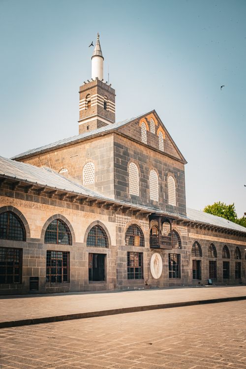 Free Beautiful stone mosque architecture under a clear blue sky, showcasing historic design. Stock Photo