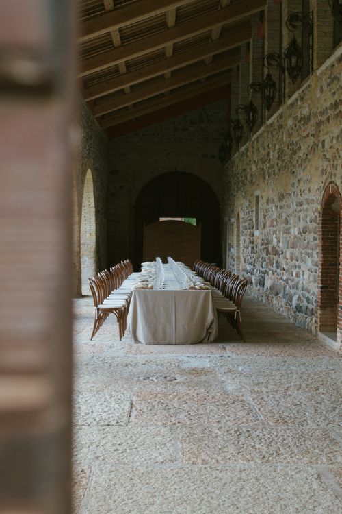 Free Long table setup in a historic Italian venue, ideal for events and gatherings. Stock Photo