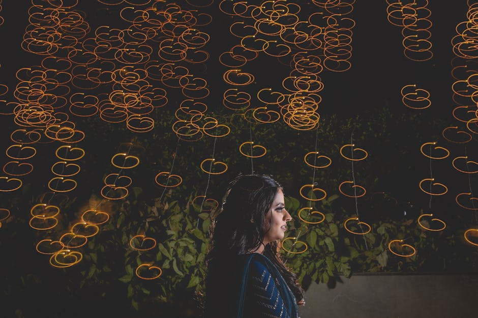 Profile of a woman in blue with artistic bokeh lights at night.