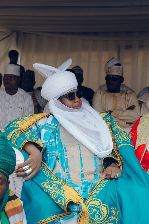 Free A vibrant display of traditional African attire at a cultural event with men in colorful garments and turbans. Stock Photo