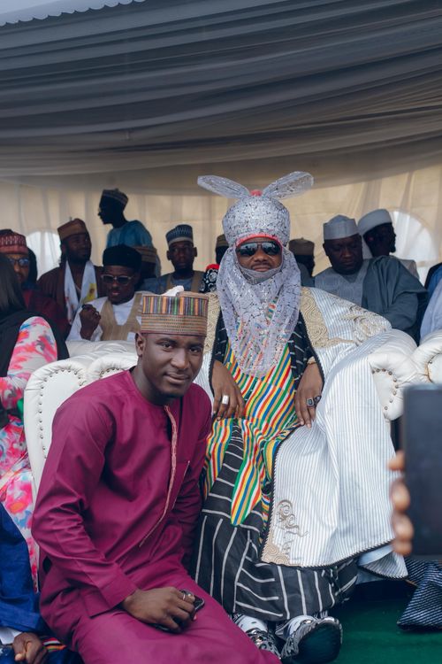 Free Group of people in traditional attire at a Nigerian Emir celebration event indoors. Stock Photo