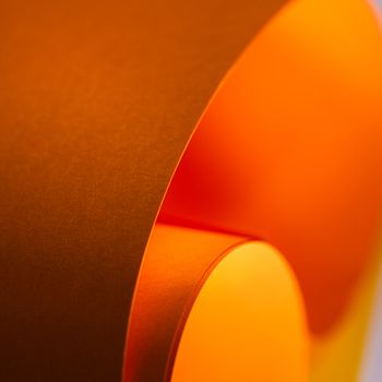Abstract image of curved orange paper with a soft gradient and elegant flow. Perfect for backgrounds and creative design concepts.