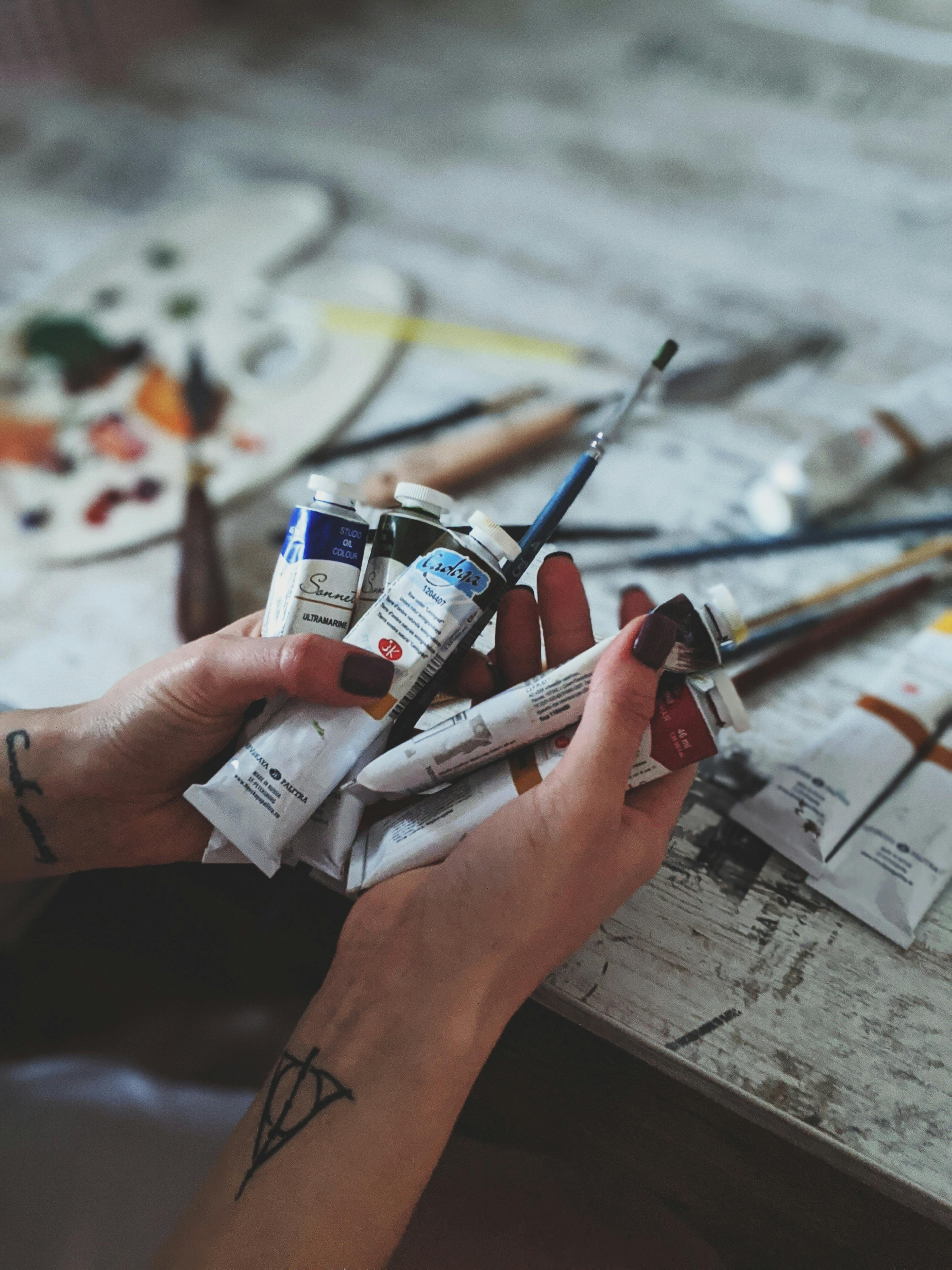 Person Holding Acrylic Paints