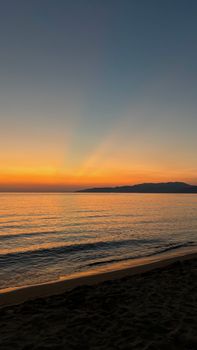 Captivating sunset over the tranquil sea at Kuşadası Beach, Türkiye, highlighting the serene Aegean coast.
