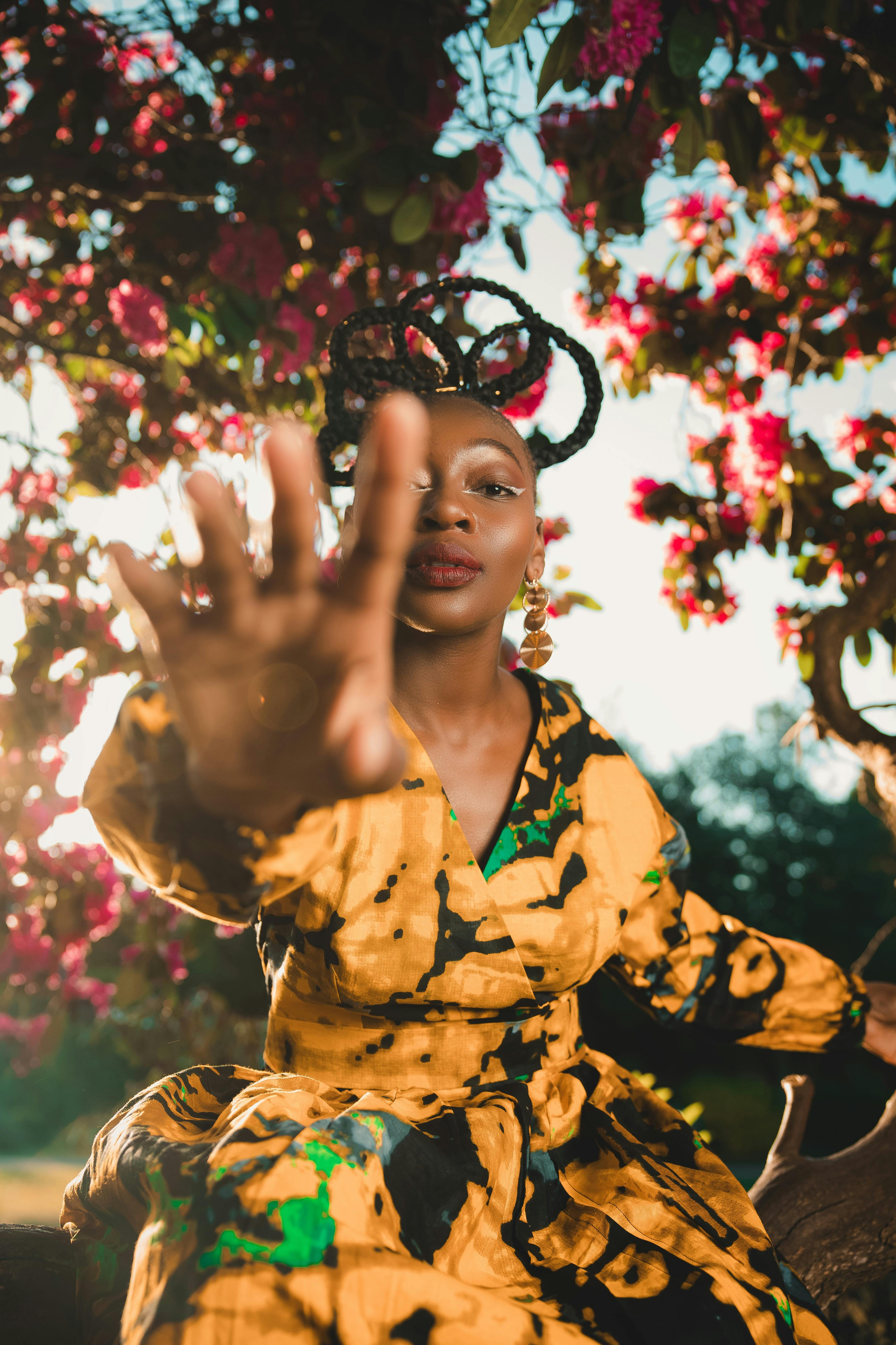 A captivating portrait of a woman in a vibrant dress with floral background, capturing beauty and culture.