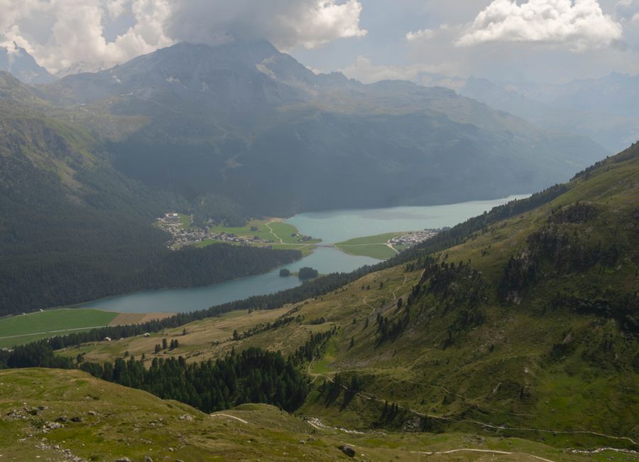 Aerial view of Lake Silvaplana and Swiss Alps, capturing serene natural beauty.