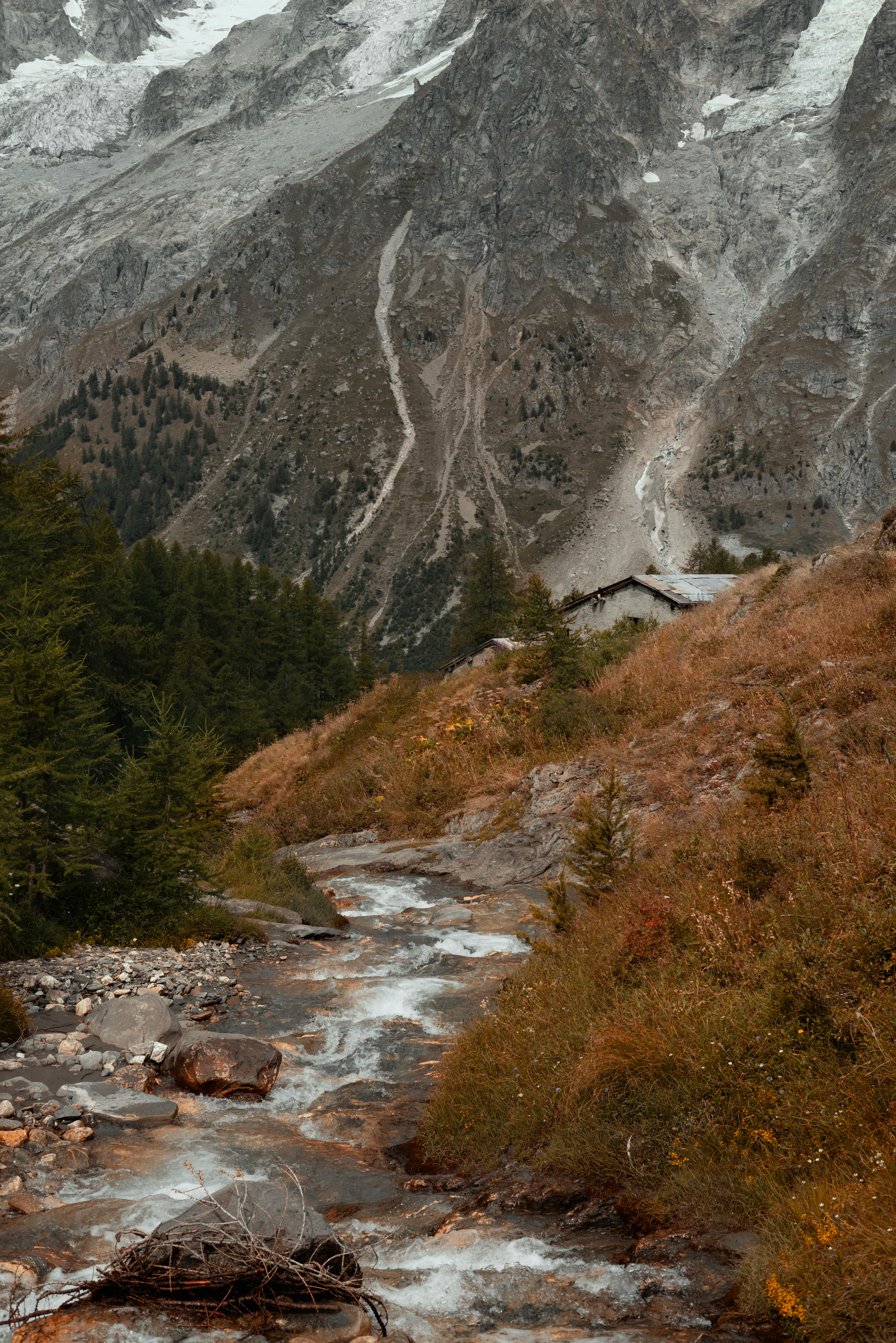 Breathtaking mountain scene featuring a flowing stream under a rocky peak.