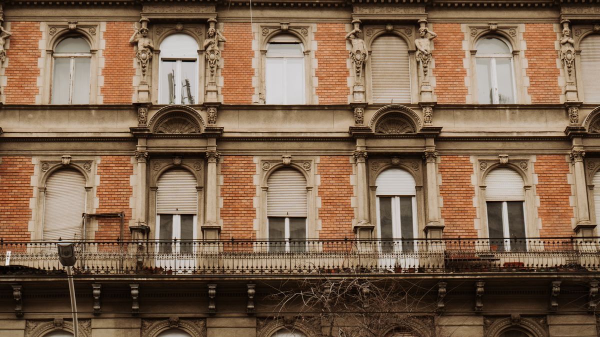 Detailed facade of a historical building with classical architecture in Budapest, Hungary.