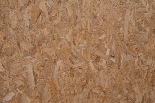 Detailed texture of a natural wooden OSB panel, perfect for backgrounds and design elements.