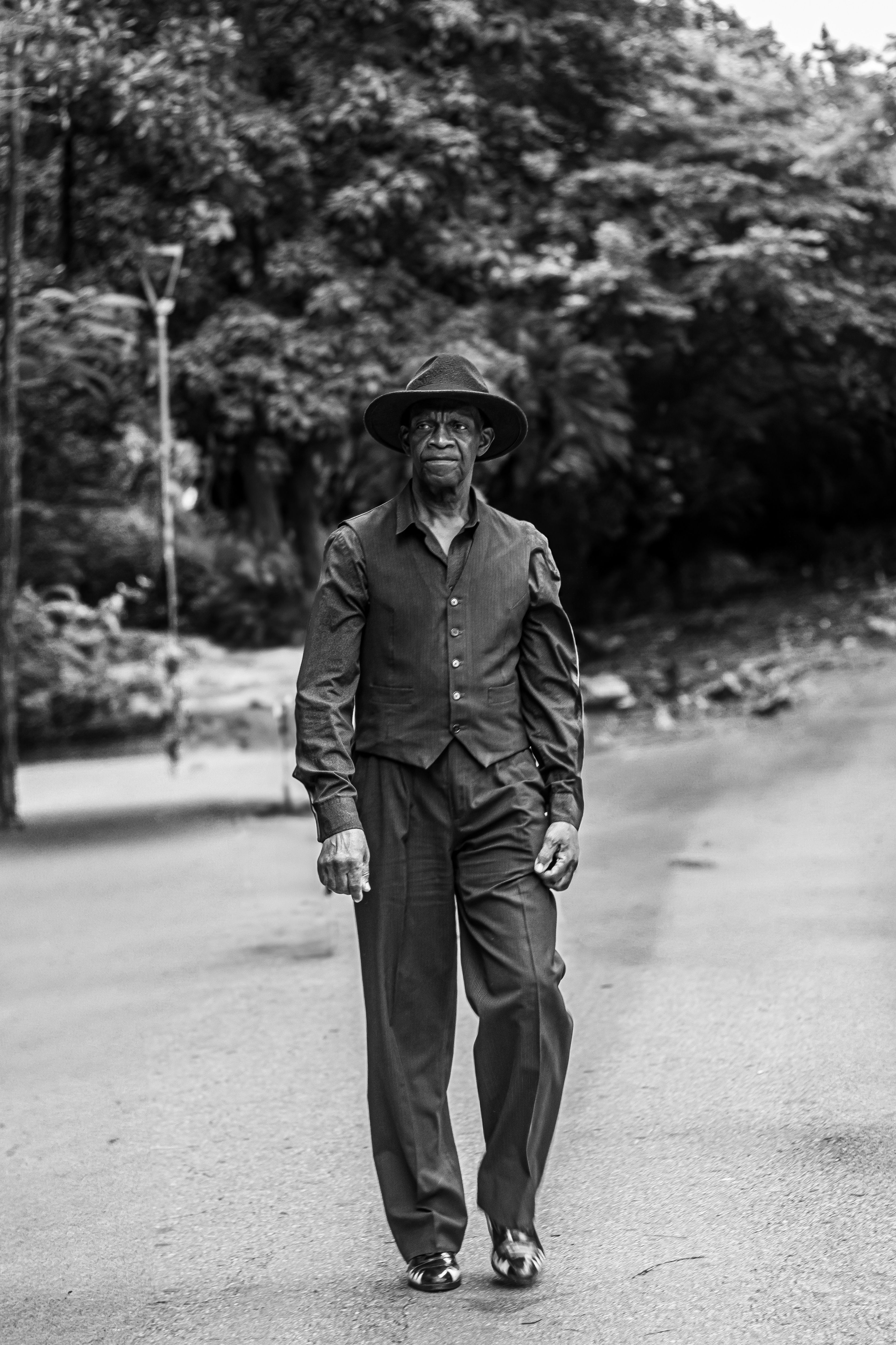 Stylish Elderly Man Walking on Street in Black and White · Free Stock Photo