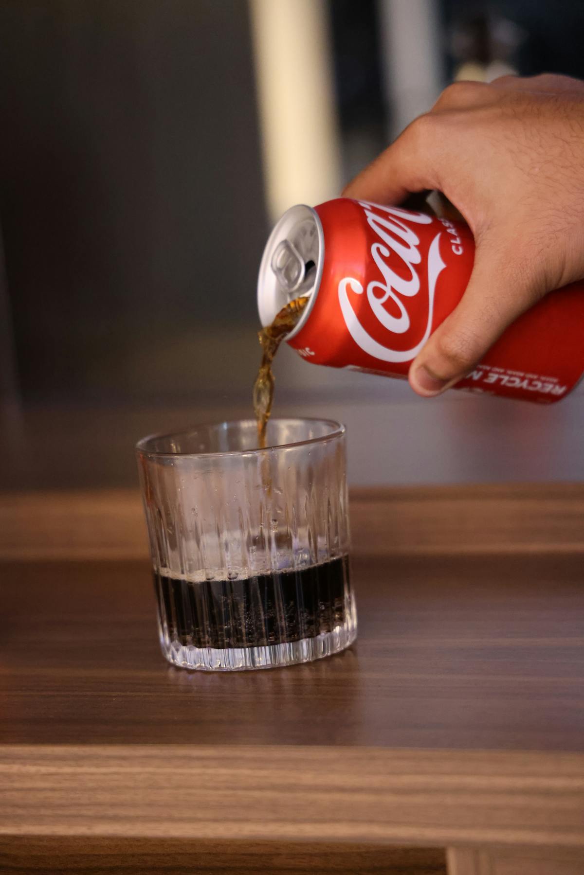 Lattina versata in un bicchiere che mostra il volume della bevanda