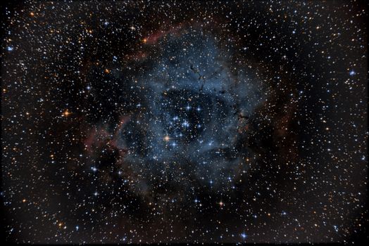 A breathtaking view of the Rosette Nebula surrounded by stars in deep space, showcasing cosmic beauty.