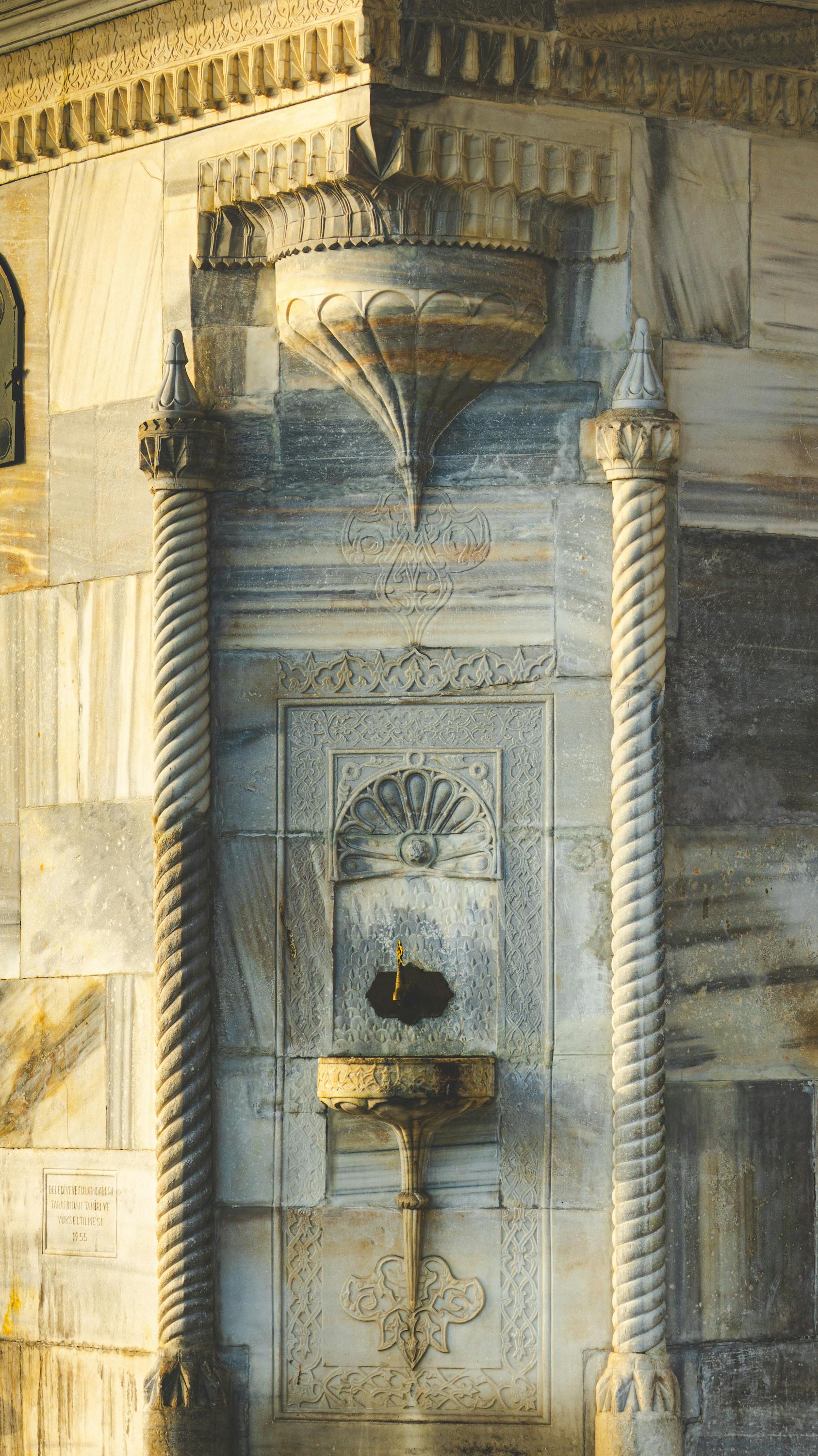 An intricately designed stone fountain showcasing traditional architectural elements.