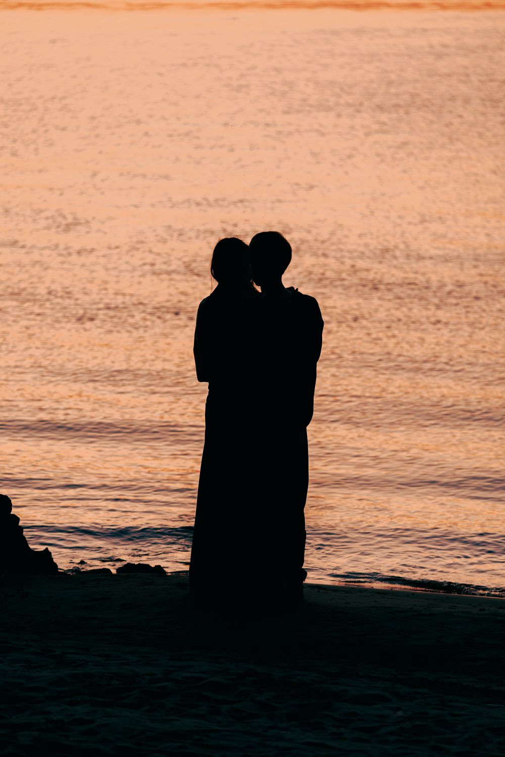 Silhouette of Couple Embracing at Sunset Beach · Free Stock Photo