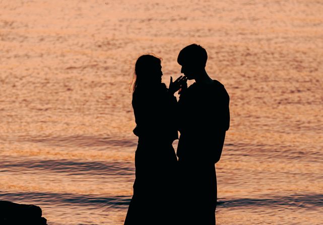couple enjoying coffee at outdoor cafe while looking at phones latin dating