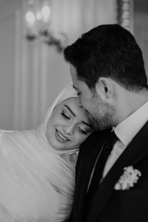 Free A black and white image of a happy couple in an elegant indoor setting. Stock Photo