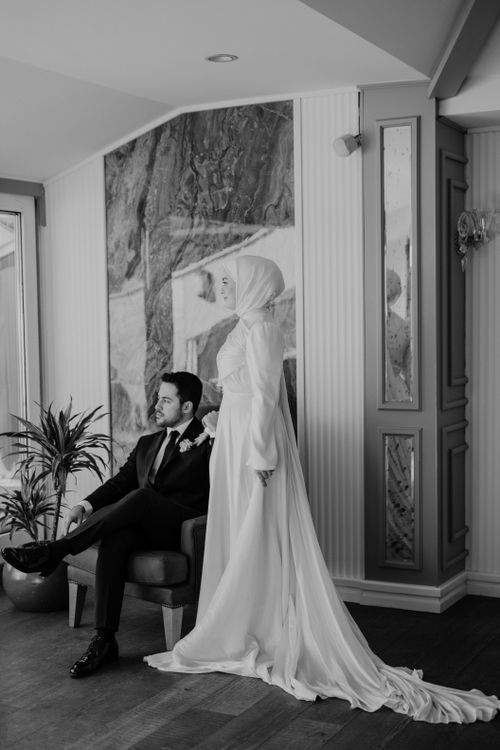 Free Stylish black and white portrait of a bride and groom indoors, showcasing elegance and grace. Stock Photo