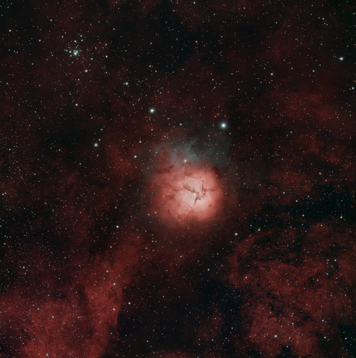 Free Captivating view of the Trifid Nebula amidst a sea of sparkling stars. Stock Photo