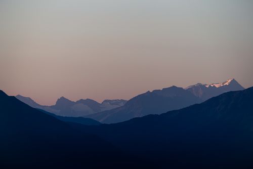 Free Peaceful twilight scene of a mountain range with pastel skies and a serene atmosphere. Stock Photo