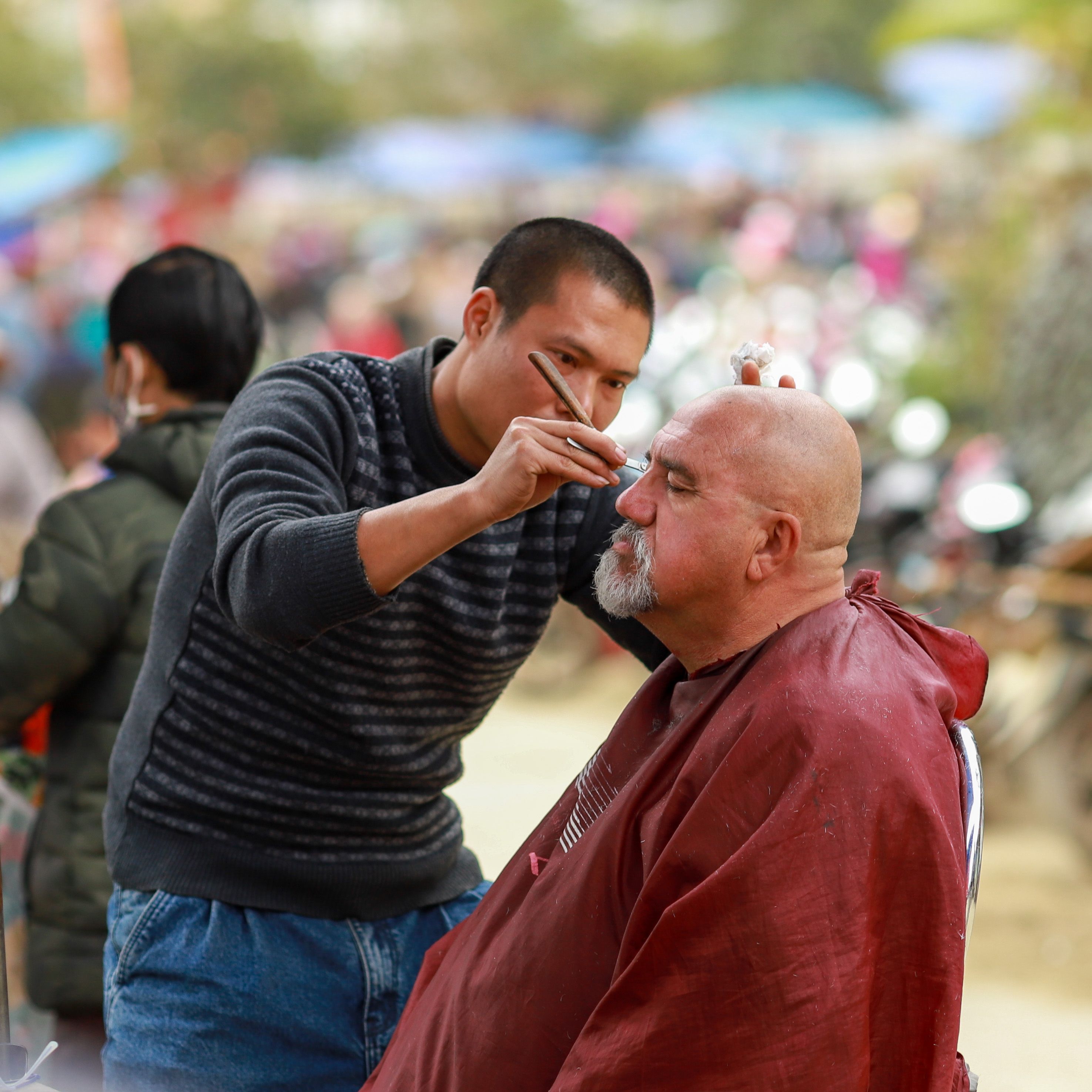 Experience a traditional haircut in Lào Cai, Vietnam, showcasing local culture and craftsmanship.