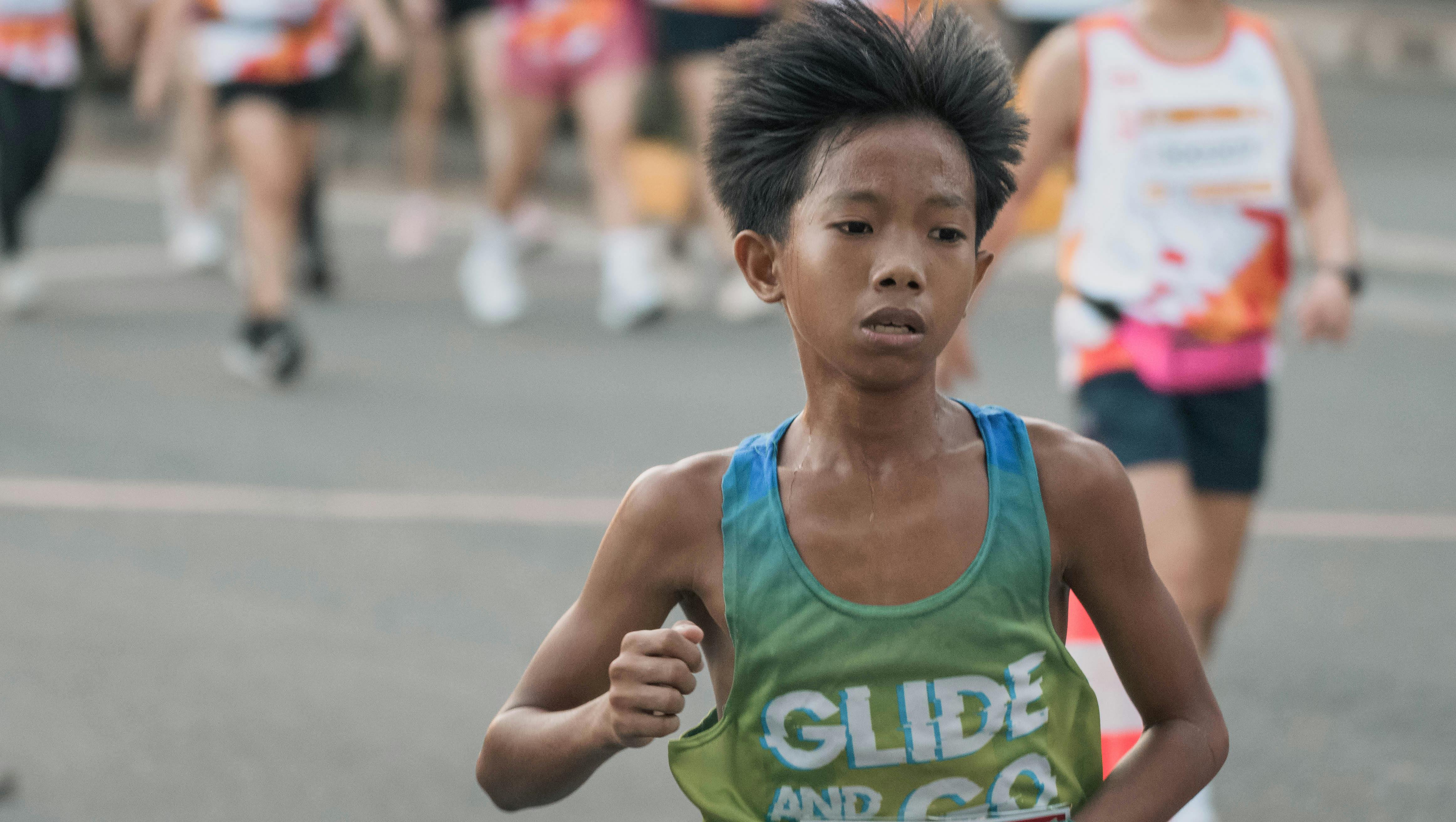 Young runner participating in a city marathon in Pasay City, Philippines.