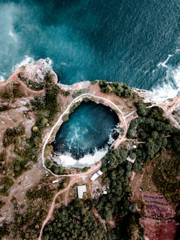 Stunning aerial view of the natural pool at Angel's Billabong with adjacent coastline in Bali.