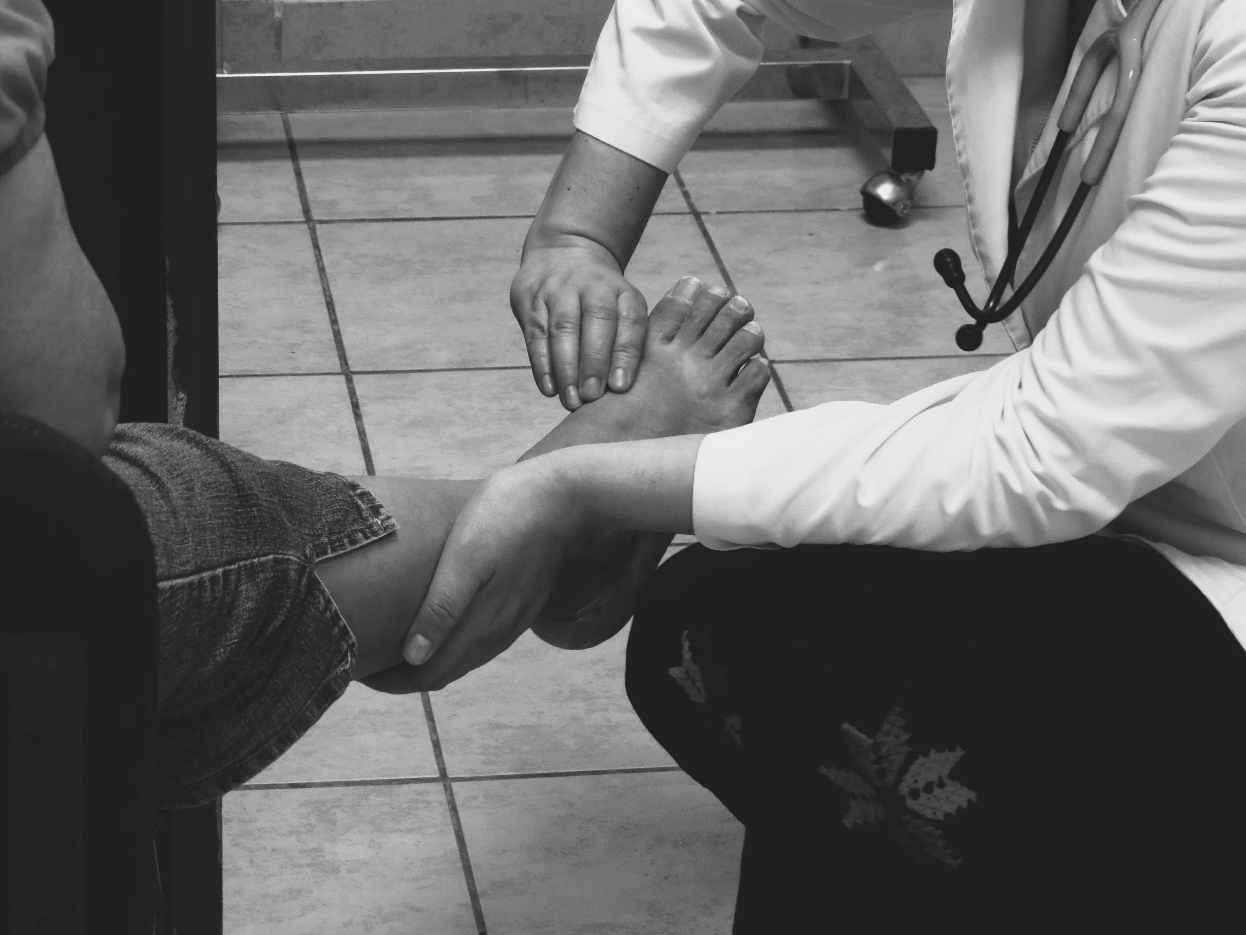 Doctor examining a patient's foot - foot nerve pain relief