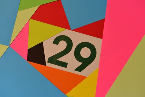Free Vibrant geometric design featuring the number 29 in various bright colors. Stock Photo