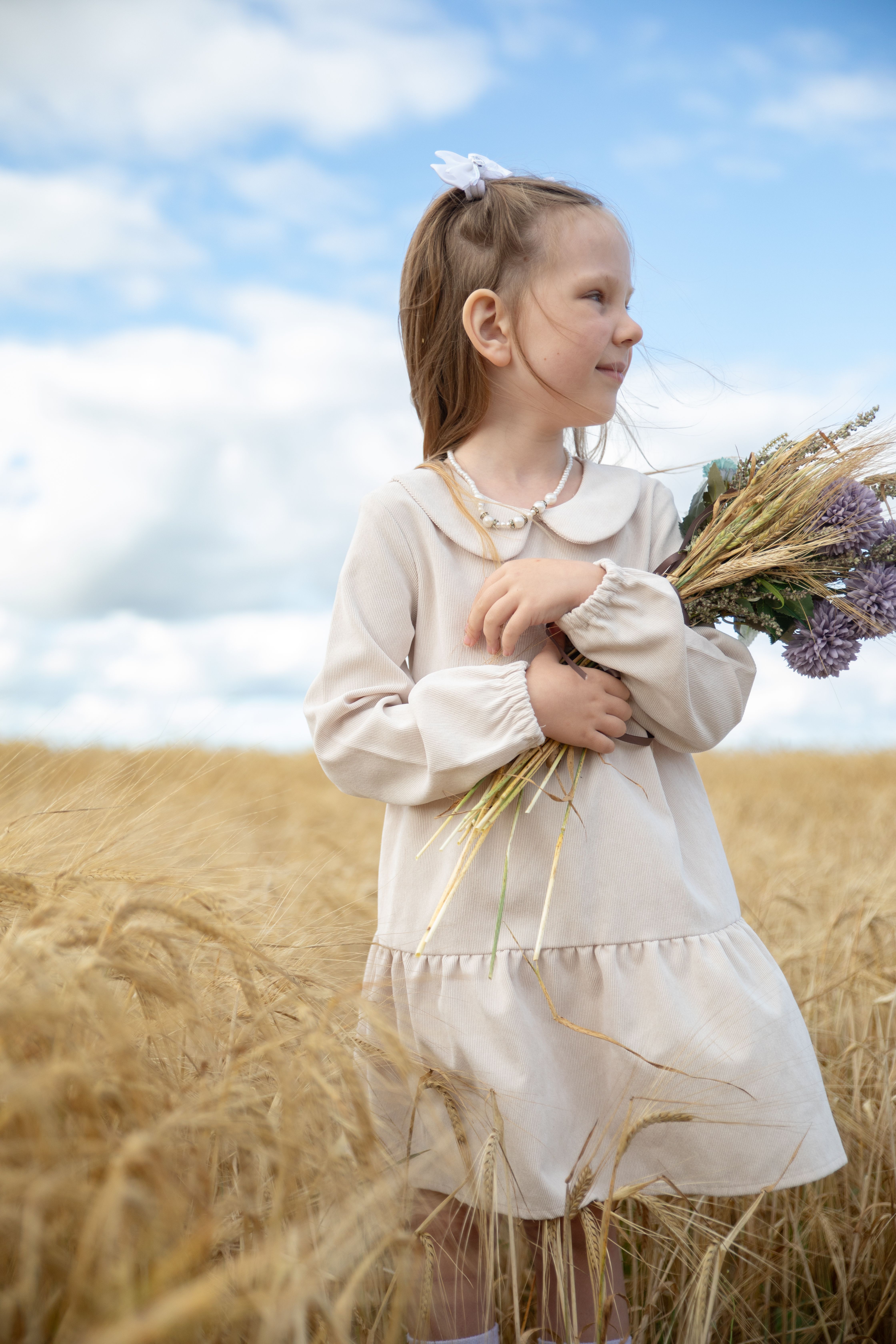 Little Girl in Wheat Field with Bouquet · Free Stock Photo