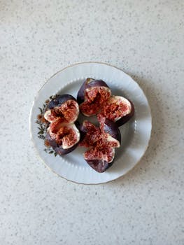Top view of fresh sliced figs on a vintage plate, ideal for food concepts.