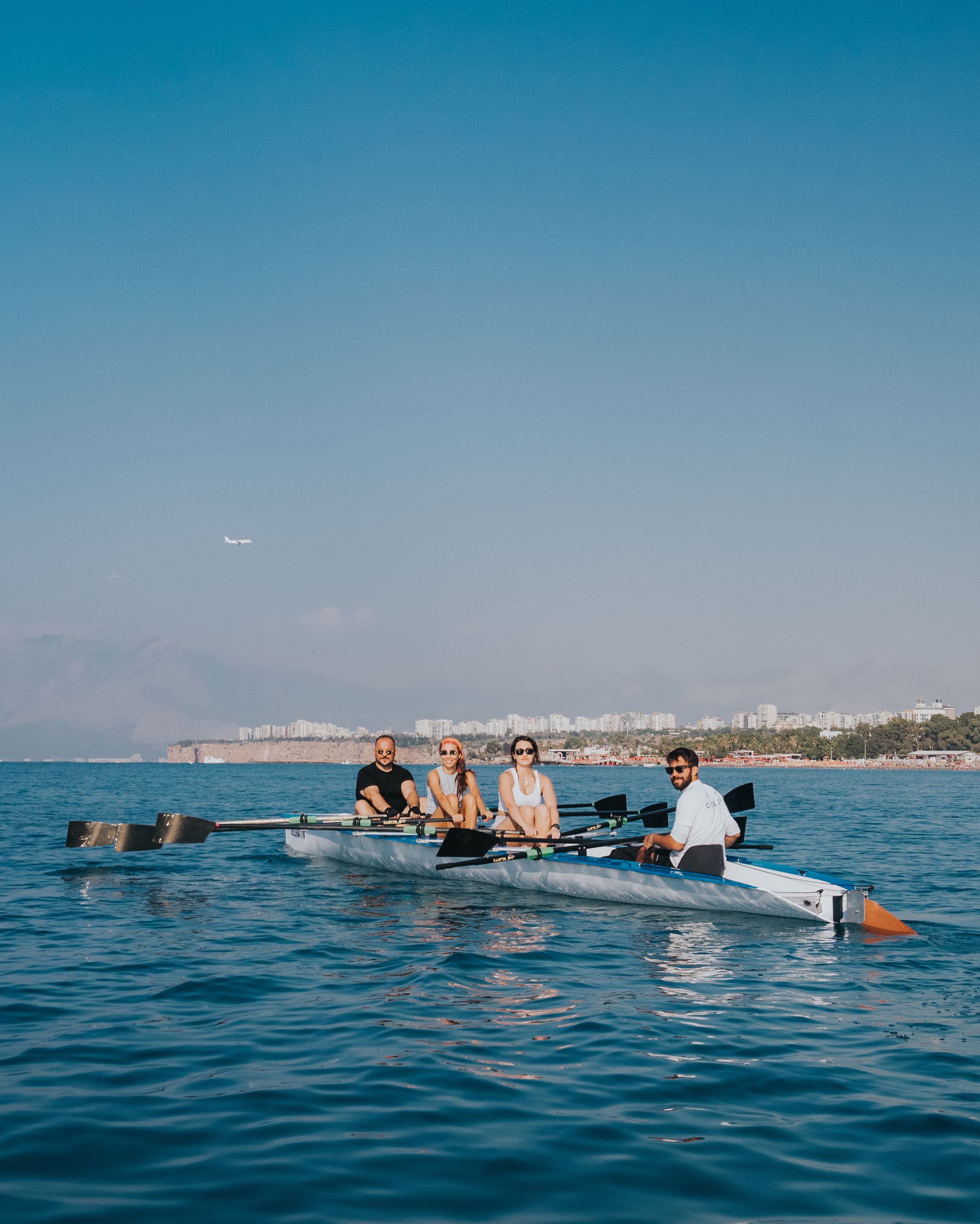 Team Rowing on Antalya Waters with Scenic Background · Free Stock Photo