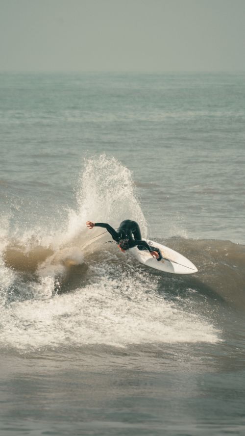 Free A dynamic shot of a surfer skillfully riding a wave in Mar del Plata, capturing the thrill of the sport. Stock Photo