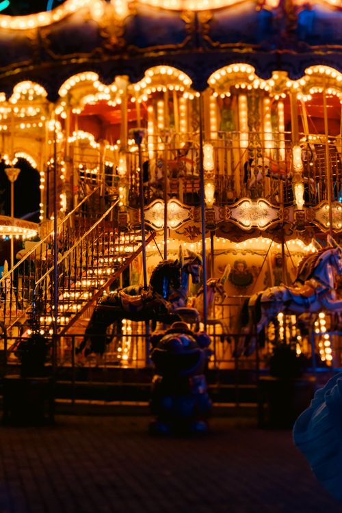 Free Vibrant carousel illuminated at night, creating a nostalgic and whimsical ambiance. Stock Photo