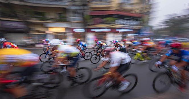 Vibrant urban bicycle race captured with motion blur emphasizing speed and competition.