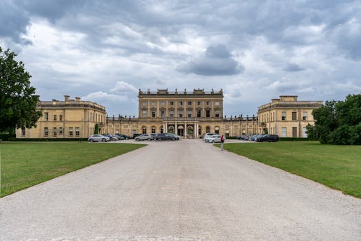 Majestic Cliveden House in Taplow, England, under a dramatic sky, showcasing classic architecture.