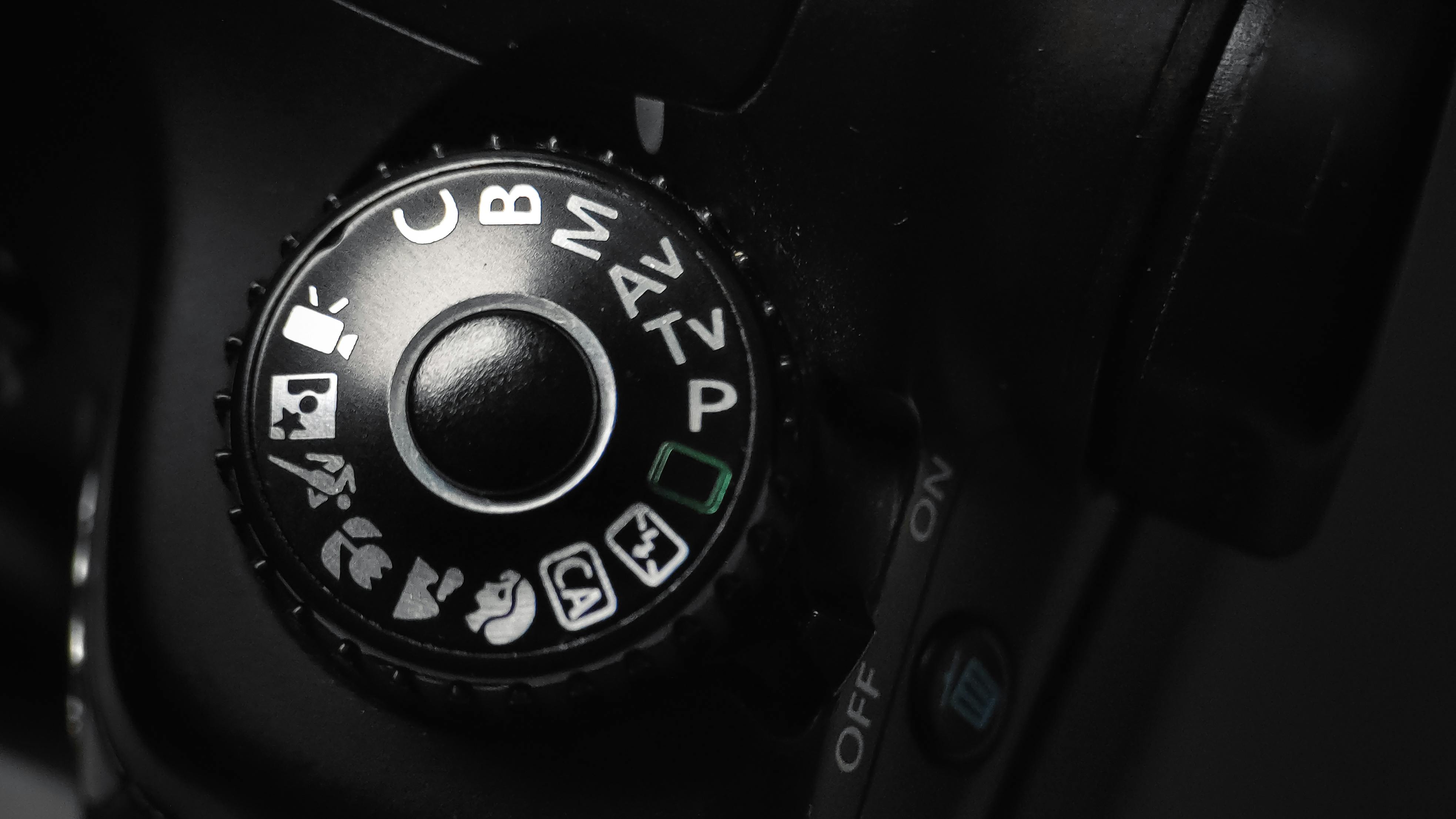 Free Detailed close-up of a DSLR camera mode dial showing various settings. Stock Photo