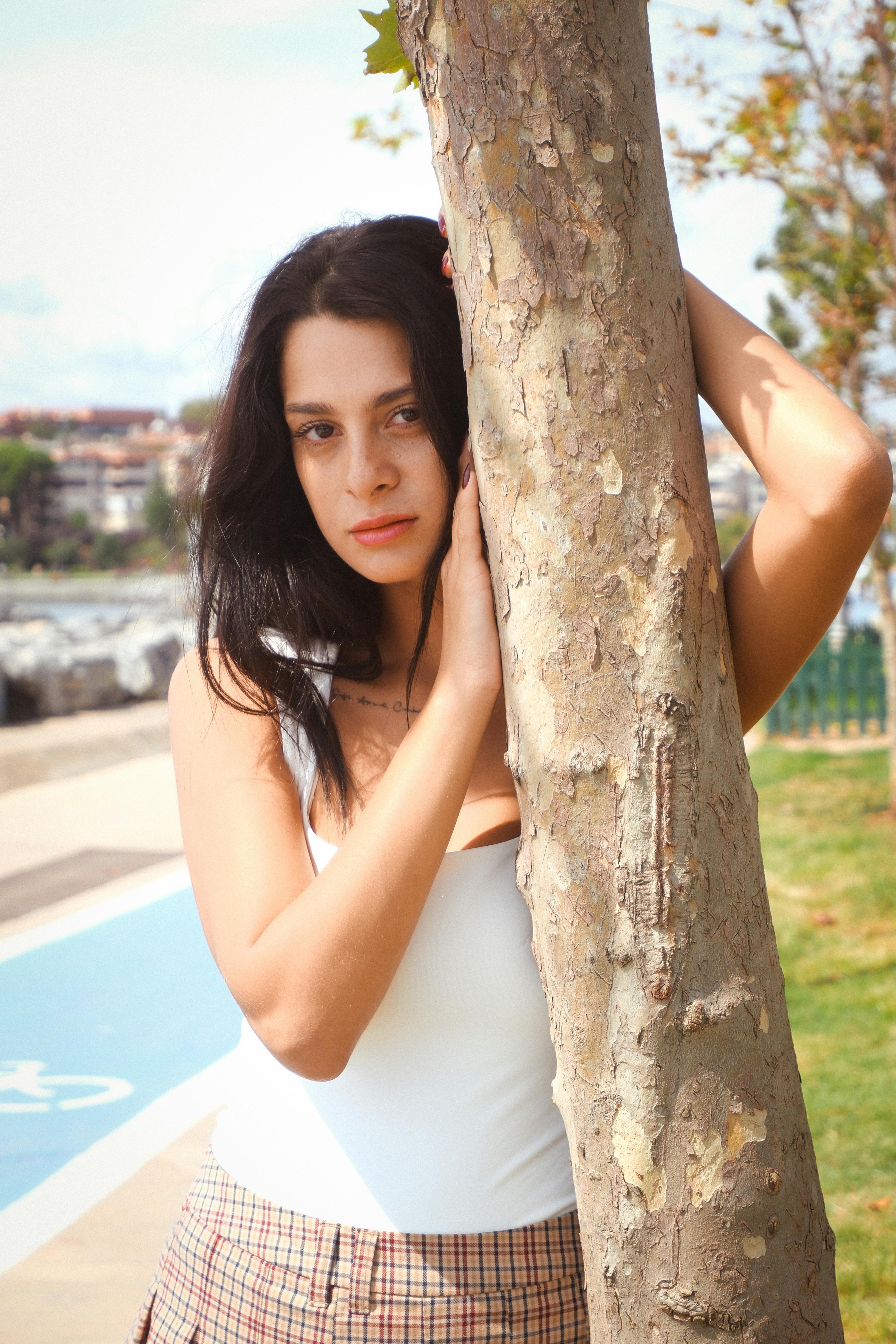 Elegant woman in a serene outdoor setting by the sea in Istanbul, Türkiye.