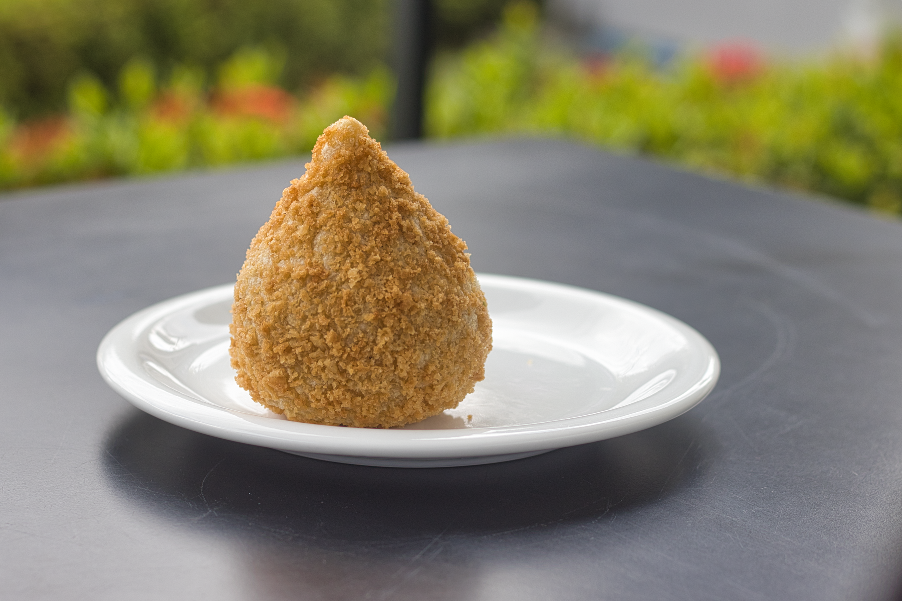 Golden Brazilian coxinha on a plate