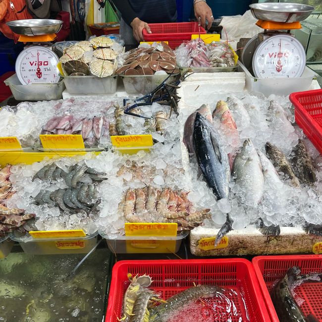 Colorful summer seafood market in Mong Cai, fresh shrimp crab fish on display, local vendors, vibrant atmosphere, cultural details, realistic travel photography