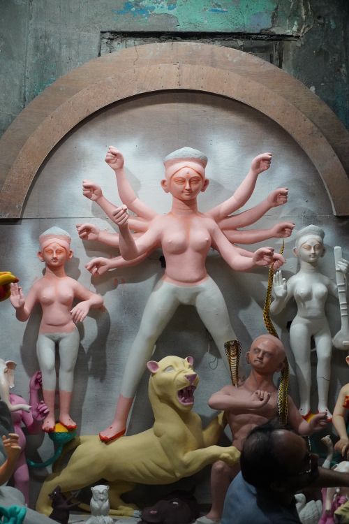 Free Unfinished clay idols of goddess Durga and her entourage in a Kolkata workshop, capturing traditional craftsmanship. Stock Photo