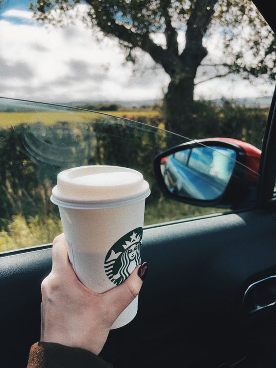 Coffee Cup Held in Car with Scenic View  Free Stock Photo