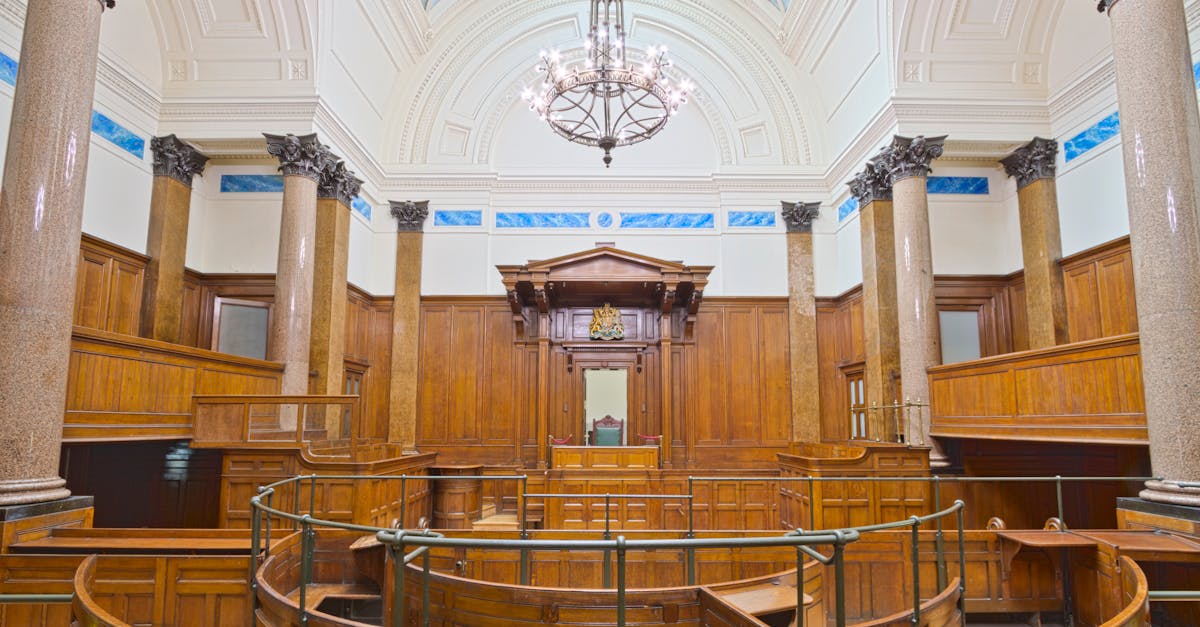 Defendant and defense attorney discussing plea deal options in a courthouse.