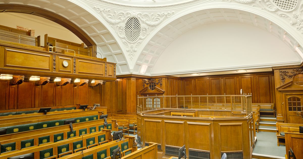 No Win No Fee Employment Law Solicitors: How CFAs Work in Tribunals — Interior view of a historic courtroom in London with ornate design and wooden furnishing.