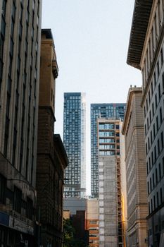 View of modern skyscrapers framed by historic buildings in downtown Montreal.