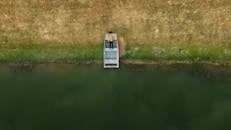 Aerial View of Man Relaxing by Lake in Pelham