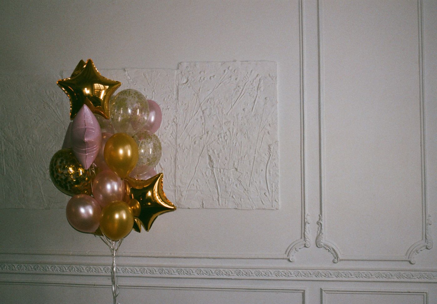 Gold and blush balloon installation for a premium birthday party